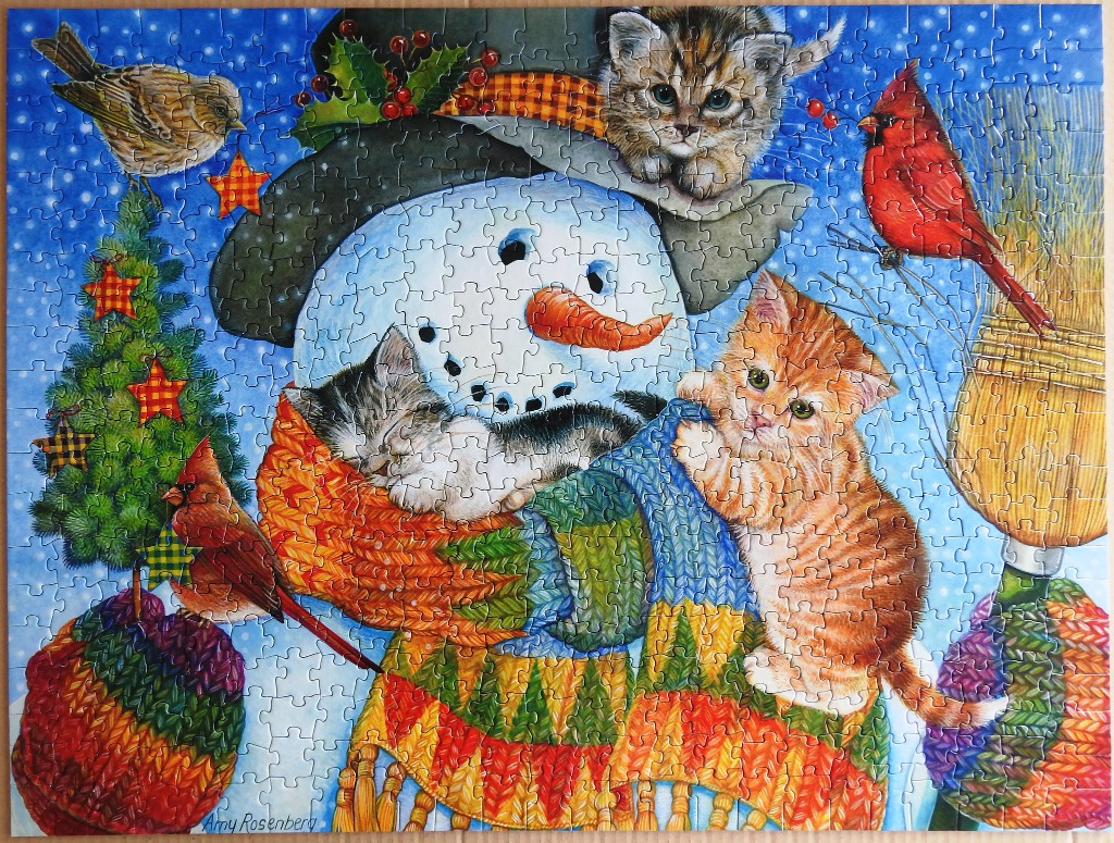 A whimsical illustration of a snowman surrounded by kittens and birds in a snowy winter setting.