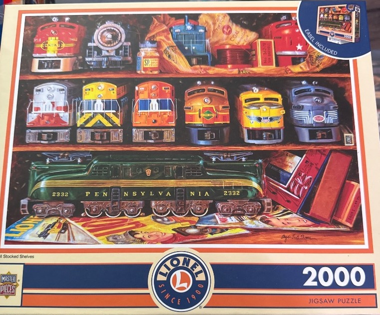 A collection of vintage toy model trains arranged on wooden shelves with a prominent green locomotive in the foreground.