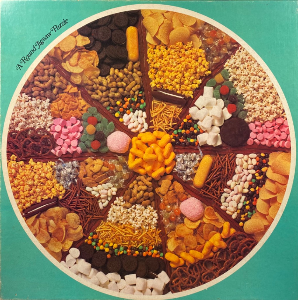 Top-down circular view of various snack foods arranged in wedge-shaped piles like a pizza.
