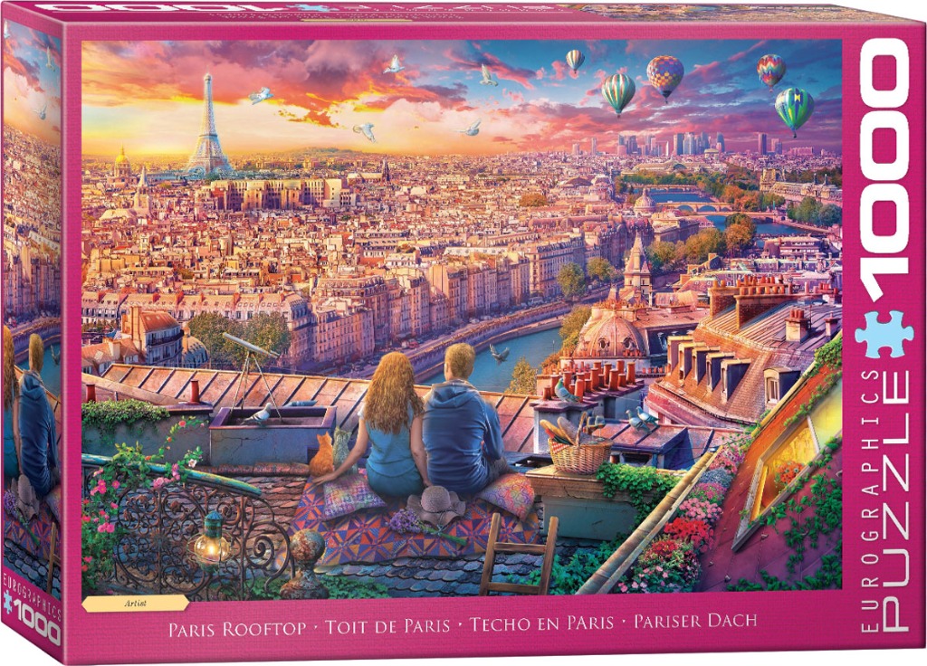 A couple sits on a Parisian rooftop at sunset, overlooking the city skyline with the Eiffel Tower in the distance.