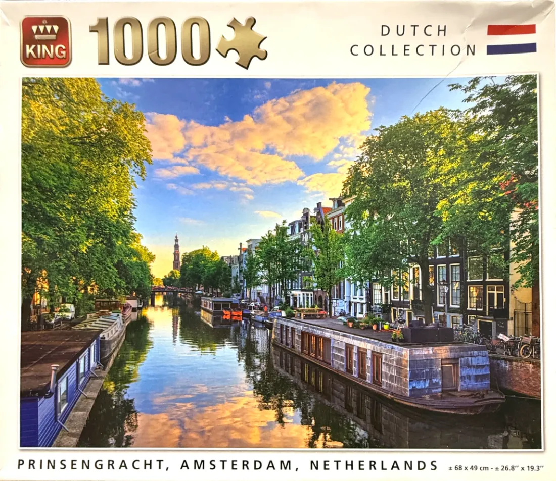 A sunny afternoon scene of the Prinsengracht canal in Amsterdam with houseboats and historic buildings.