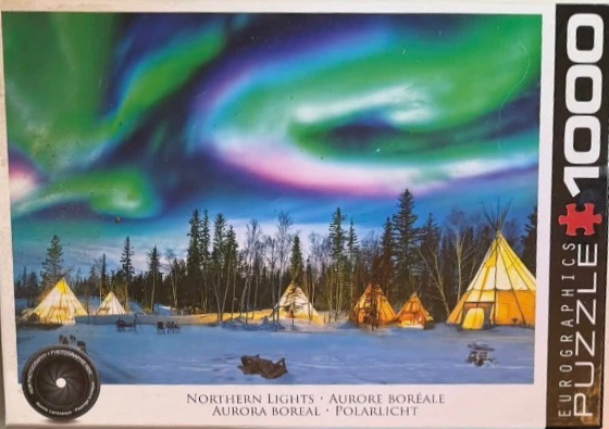 Vibrant Northern Lights over a snowy landscape with several illuminated tipis in a forest clearing.