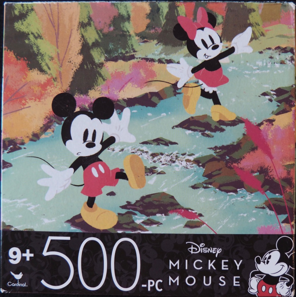 Mickey and Minnie Mouse hopping across stones in a forest stream during autumn.