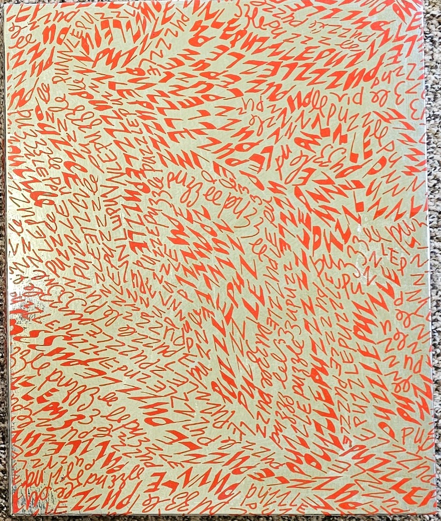 A repeating pattern of the word PUZZLE in orange hand-lettered script over a metallic gold background.