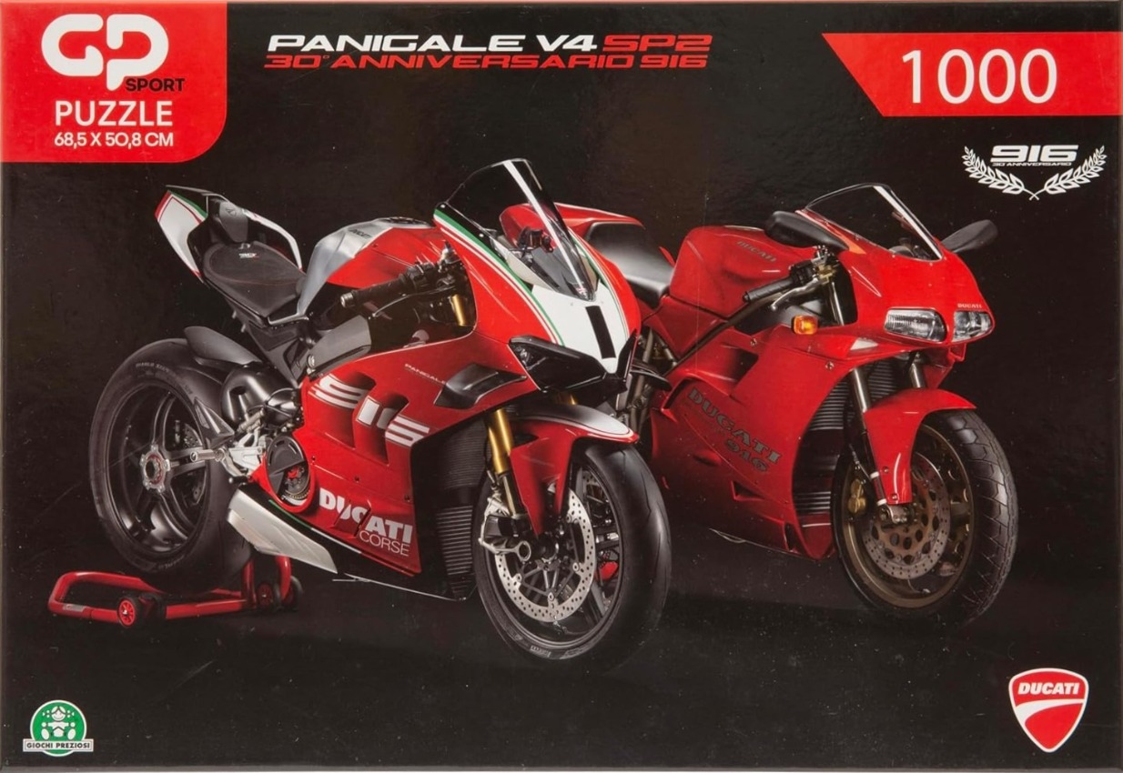Two red Ducati motorcycles, a modern Panigale V4 and a classic 916, parked against a black background.