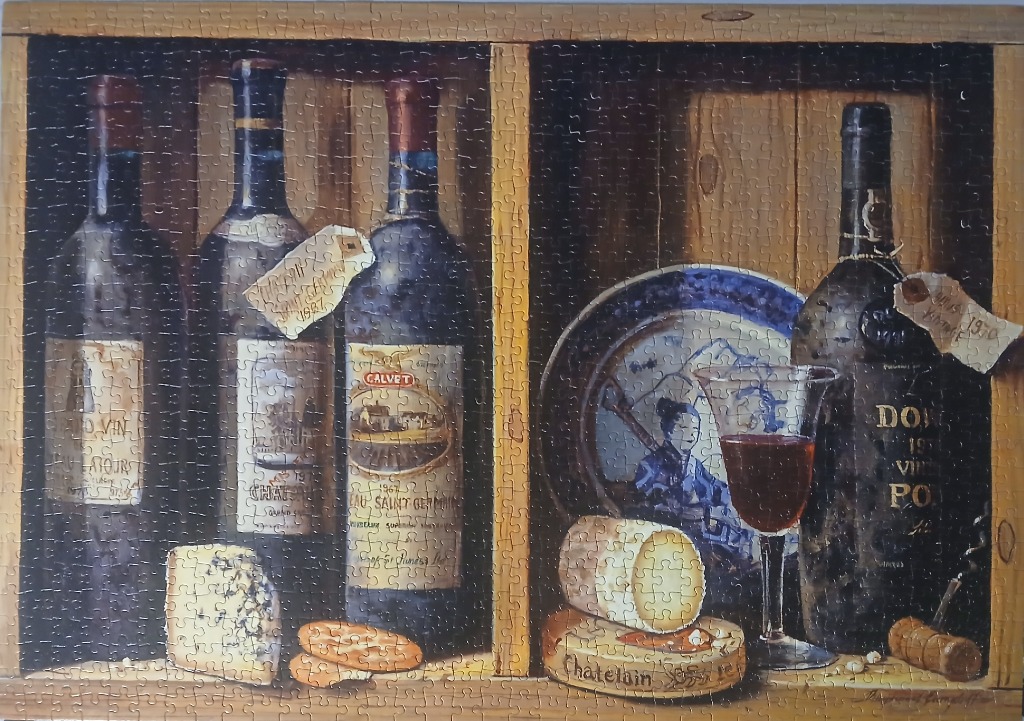 A still life oil painting of wine bottles, cheese, and a decorative plate inside wooden shelving.