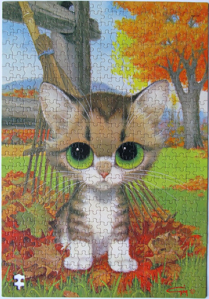 A cartoon-style tabby kitten with large green eyes sitting in autumn leaves near a wooden rake.