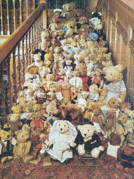 A large collection of teddy bears arranged on a wooden staircase