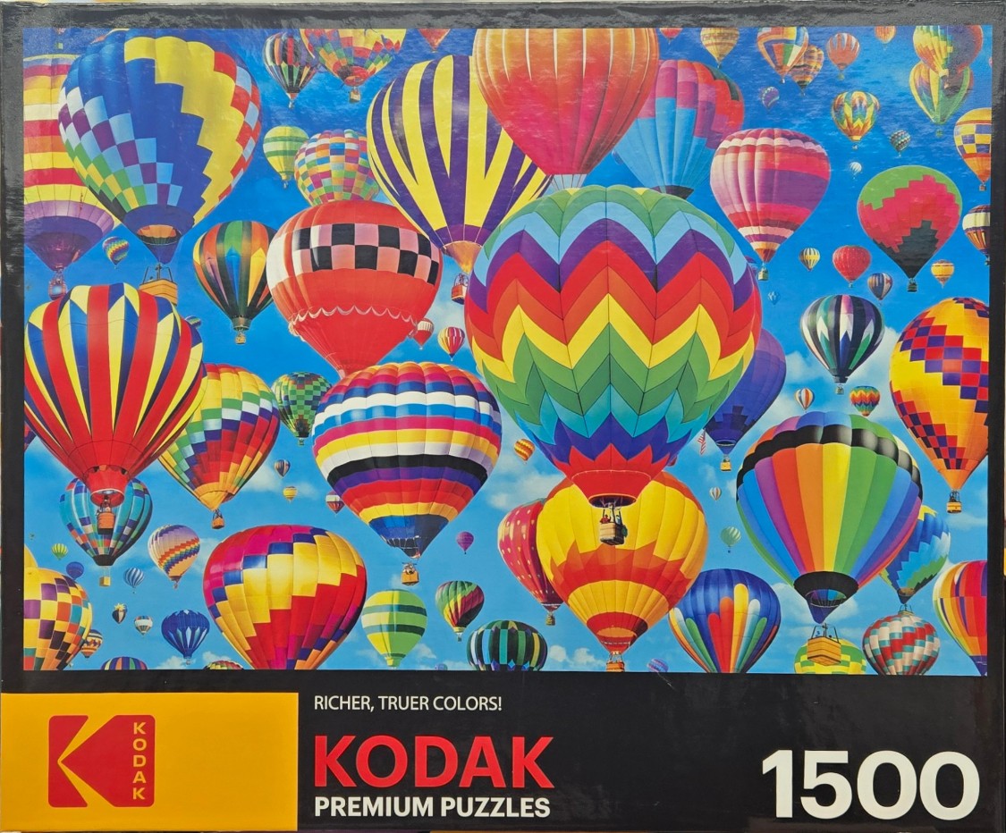 A vibrant sky filled with dozens of colorful hot air balloons in various patterns.