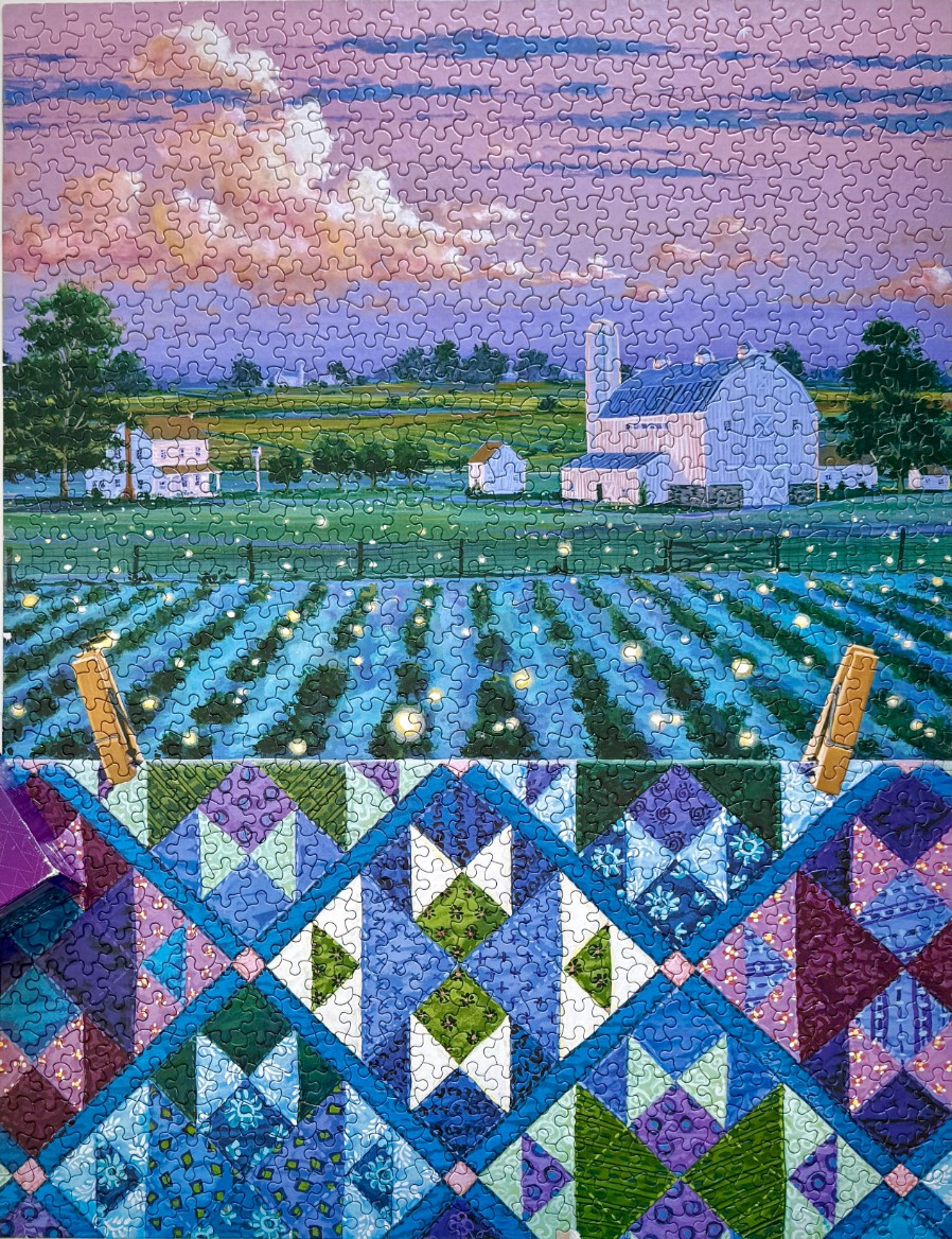 A countryside scene at dusk featuring a glowing firefly field behind a hanging quilt.