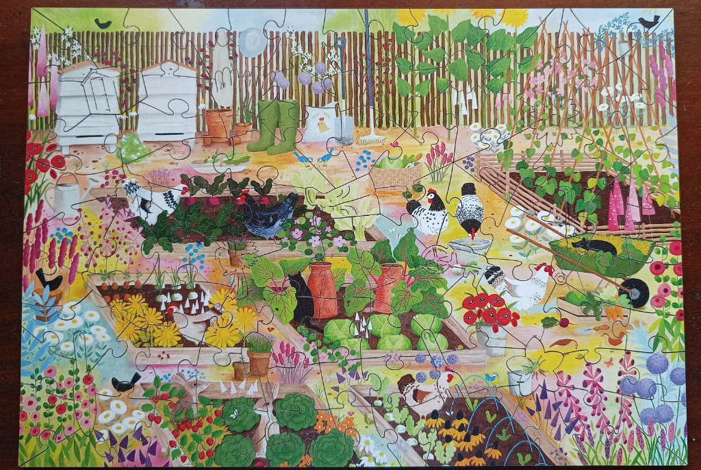 An illustration of a vibrant cottage garden filled with chickens, raised vegetable beds, and beehives.
