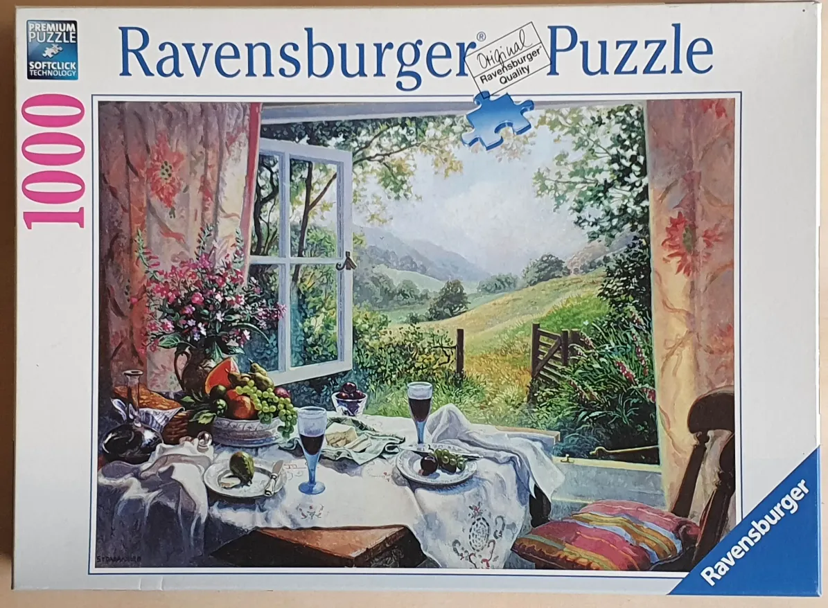 A peaceful still life of a dining table set near an open window overlooking a lush green valley.