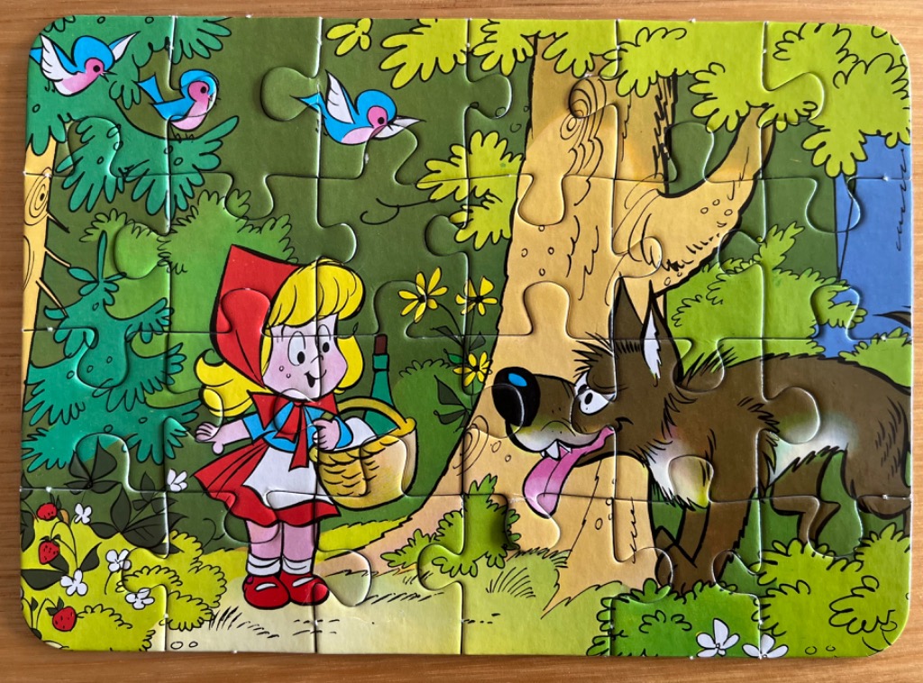 Illustration of Little Red Riding Hood meeting the Big Bad Wolf in a cartoon forest.
