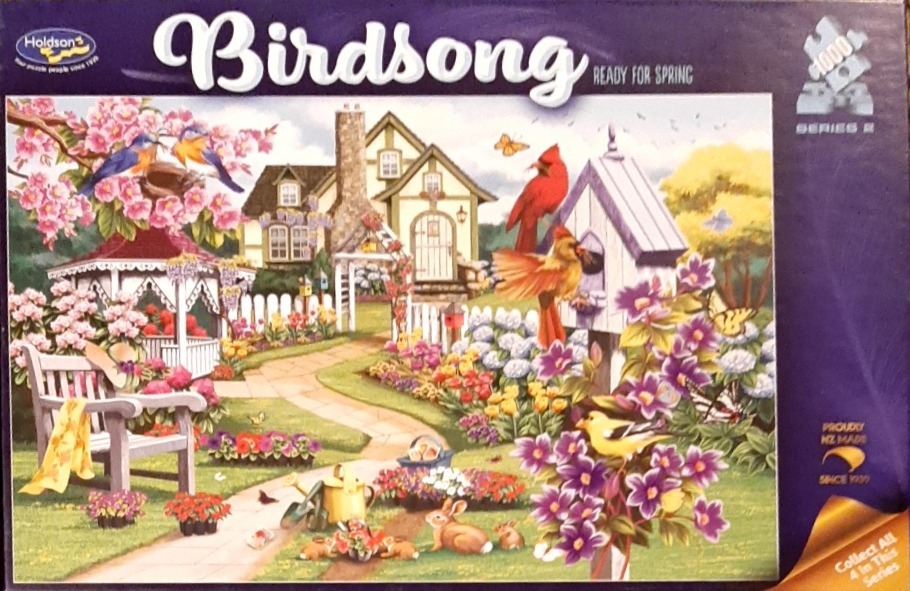 An idyllic spring garden scene with a stone cottage, a gazebo, colorful flowers, birds, and rabbits.