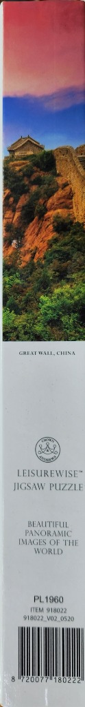 Great Wall of China under a vibrant blue and pink sky, with rugged terrain and greenery.