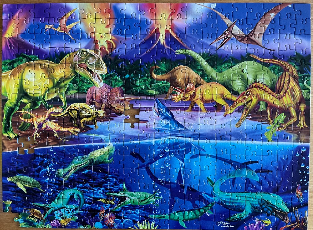 Illustration of various prehistoric dinosaurs on land and aquatic creatures in the ocean below.