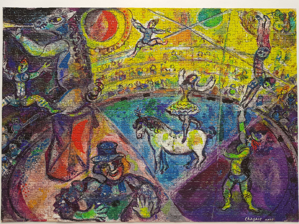 A Marc Chagall painting depicting a chaotic and vibrant circus scene with performers, animals, and an audience.