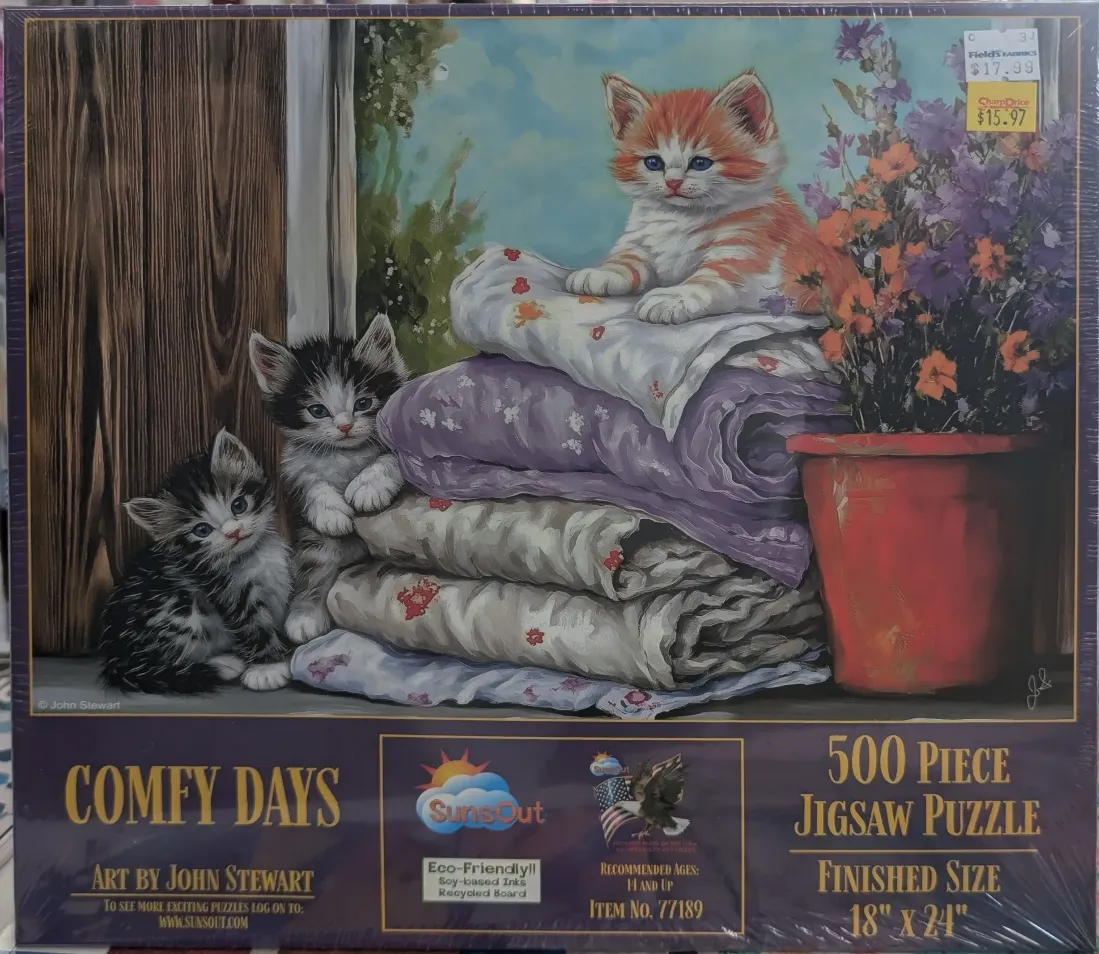 An illustration of three kittens resting on a stack of folded quilts next to a potted plant.