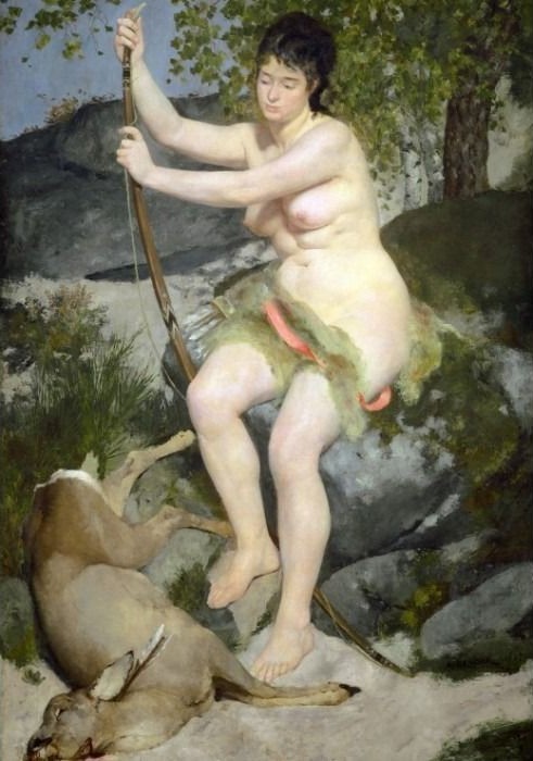 A seated woman with a bow and arrow sitting beside a fallen deer in a woodland setting.