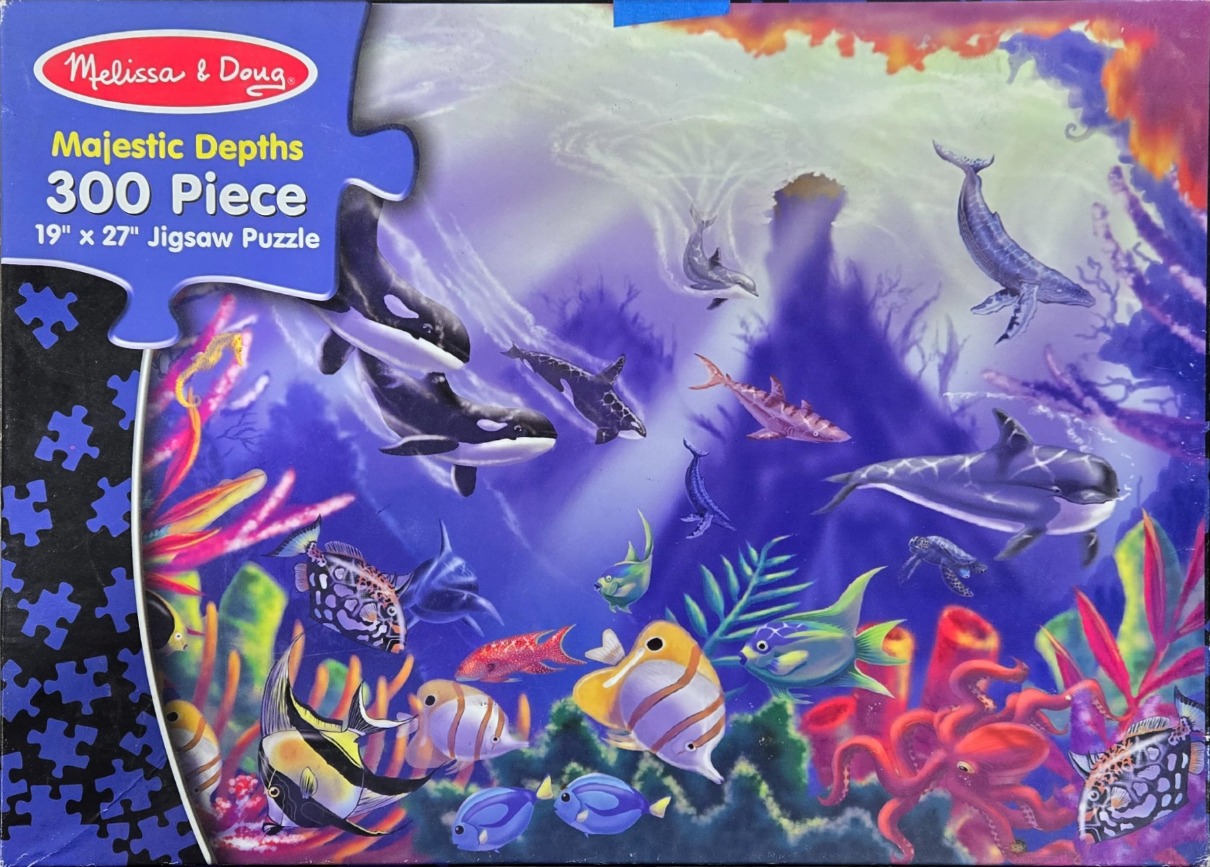 Underwater scene featuring diverse marine life including orcas, whales, and colorful tropical fish.