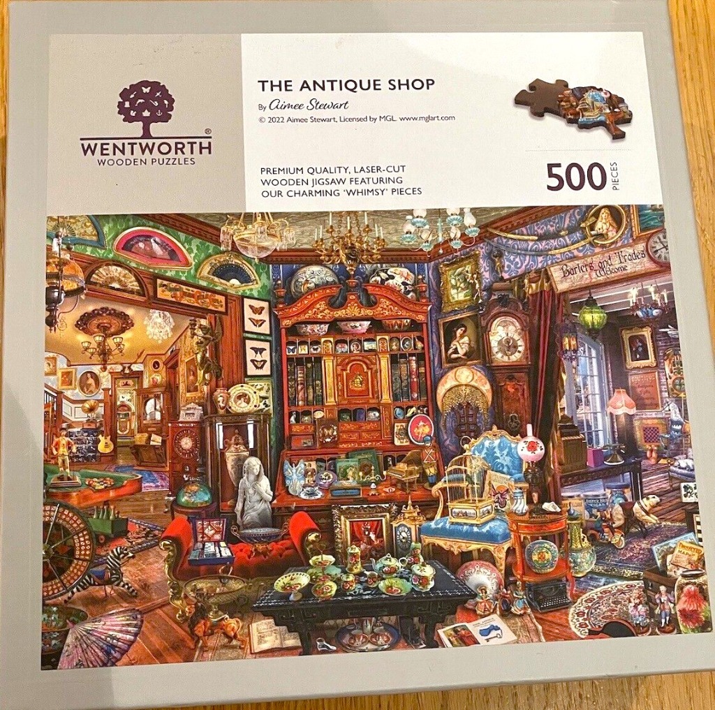 A cluttered, richly decorated antique shop interior featuring period furniture, collectibles, and warm, ornate lighting.
