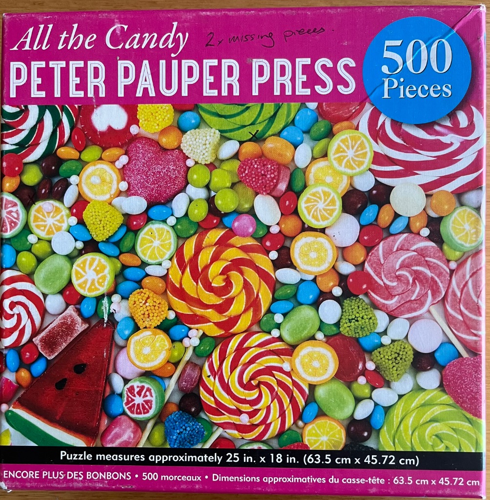 A dense, colorful assortment of various candies, including swirled lollipops, fruit slices, and sugar-coated jellies.