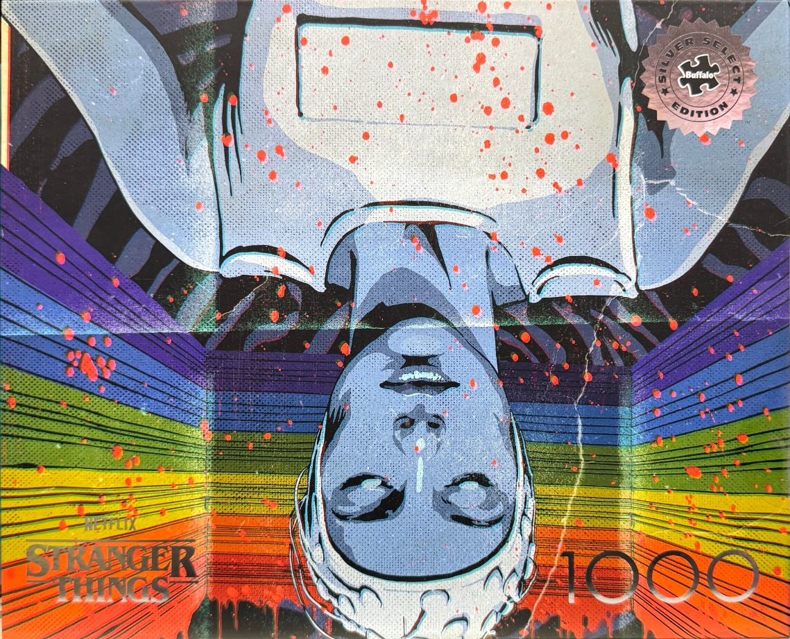 Upside-down illustration of a person with electrodes on their head against a rainbow-striped background with red splatters.