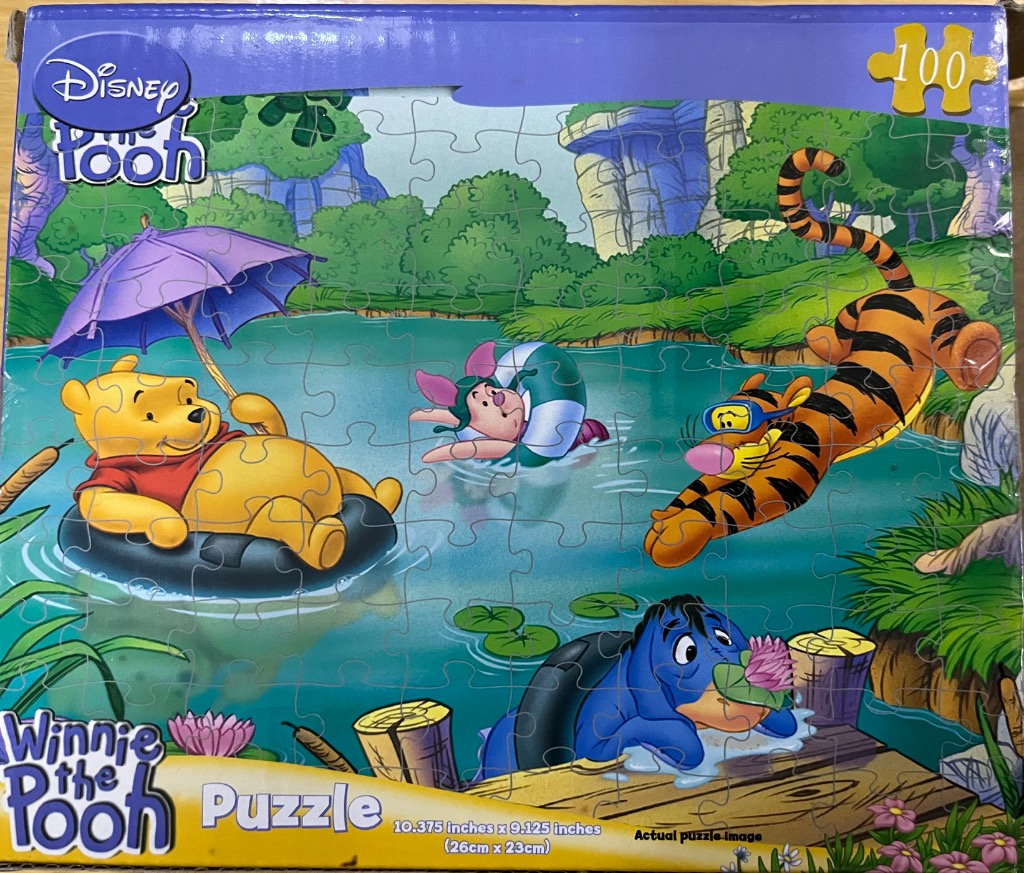 Winnie the Pooh and friends relaxing in a pond on a summer day