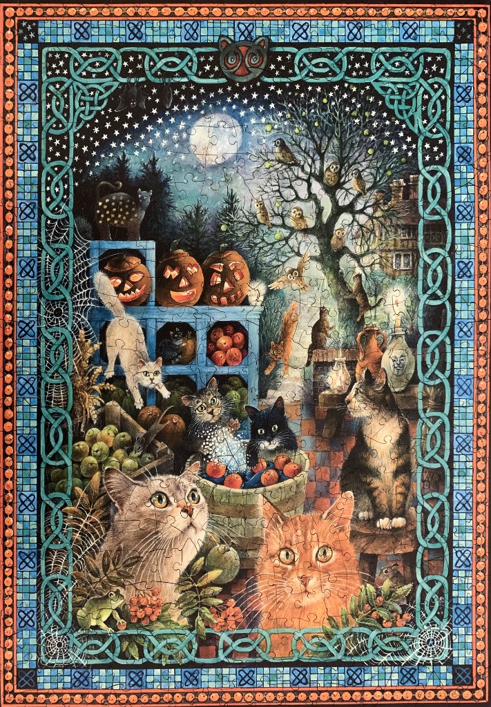 A whimsical Halloween-themed illustration featuring many cats under a starry night sky surrounded by a Celtic knot border.