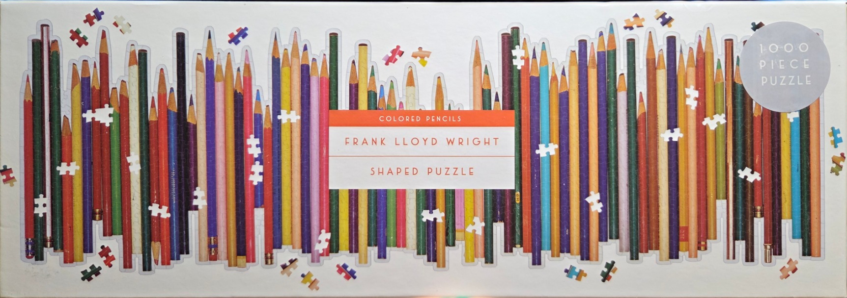 A panoramic arrangement of vertical colored pencils in a variety of shades against a white background.