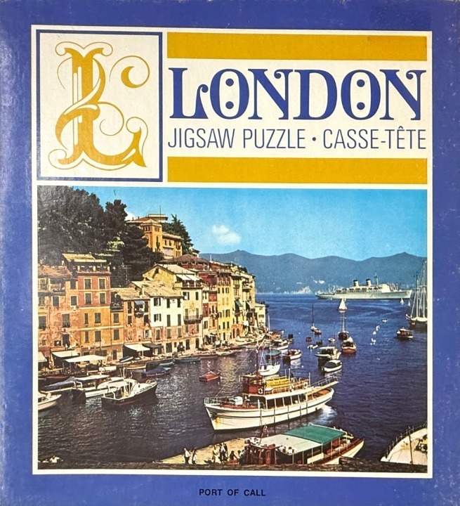 A Mediterranean harbor scene featuring colorful buildings along the water, a cruise ship, and various boats.
