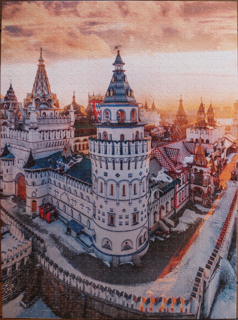 An aerial view of the colorful Izmailovsky Kremlin in Moscow during a snowy sunset.