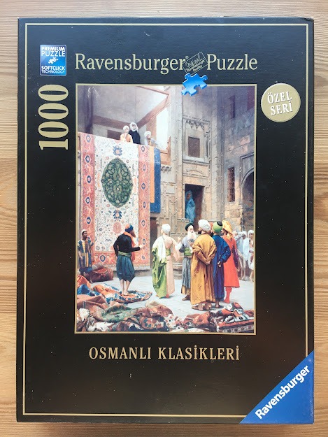 An Orientalist painting of a busy carpet market in an Ottoman courtyard with traders and customers.