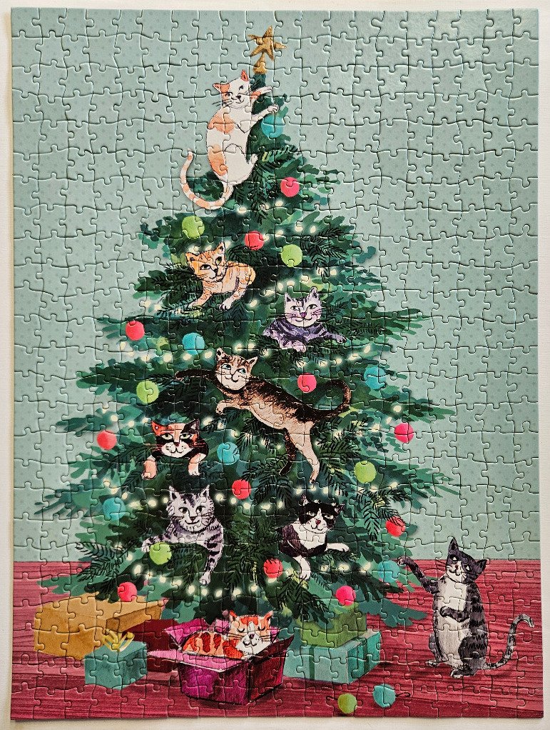 A whimsical illustration of several cats climbing and playing in a Christmas tree surrounded by wrapped gifts.