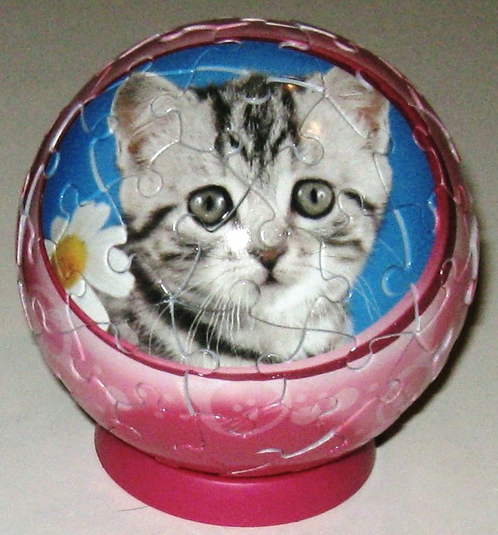 A spherical object decorated with a kitten and daisies