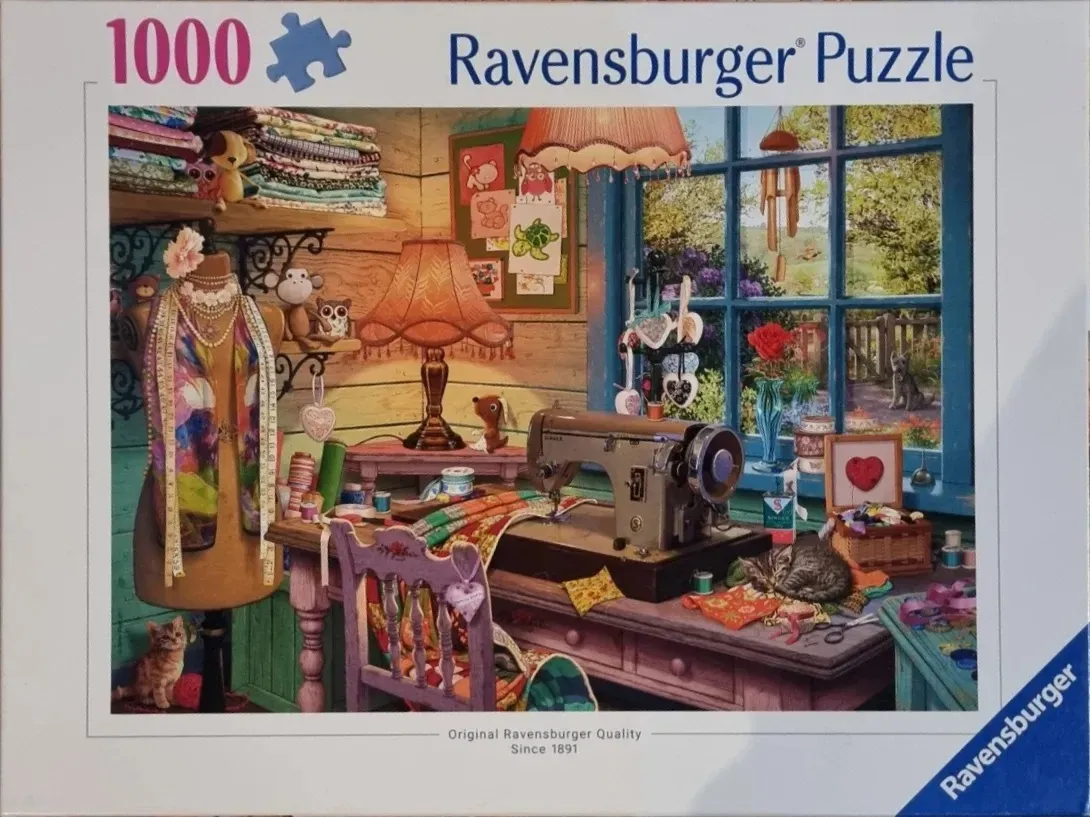 A cozy craft room scene with a vintage sewing machine, a dress form, and sleeping kittens near a window.