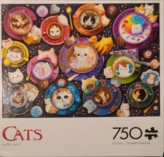 A top-down view of many colorful coffee cups decorated with latte art cats surrounded by sweets on a dark background.