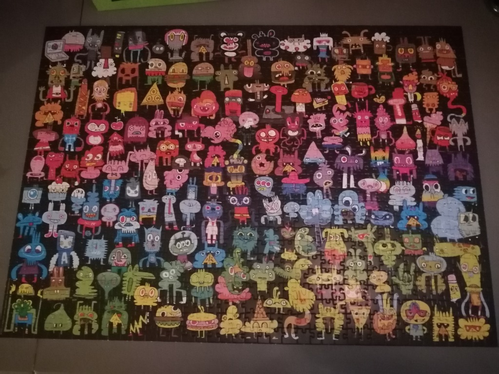 A grid of dozens of colorful, whimsical cartoon monsters against a black background.