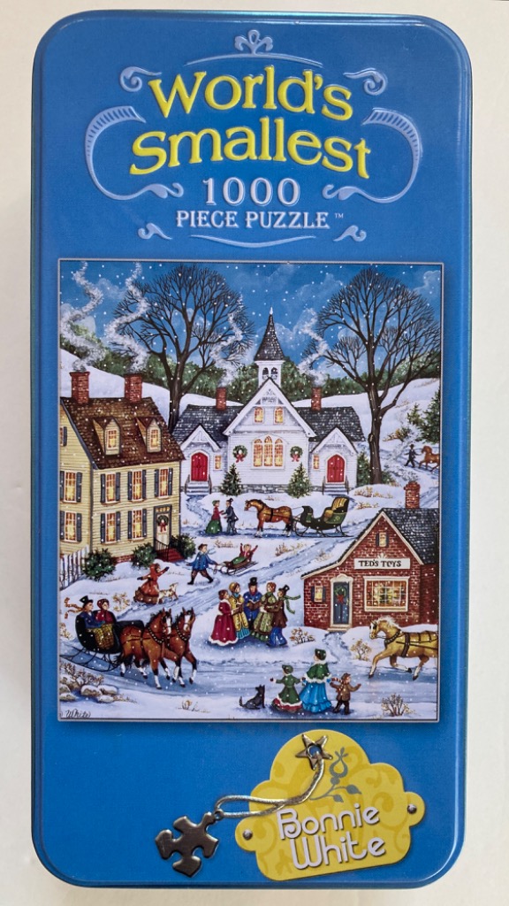 Winter village scene with a white church, historic houses, and people riding horse-drawn sleighs in the snow.