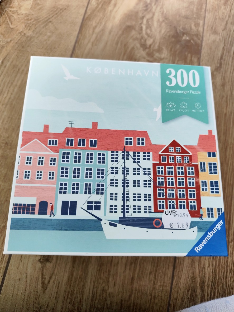 A flat, minimalist illustration of colorful Copenhagen buildings along a canal with a white boat in the foreground.