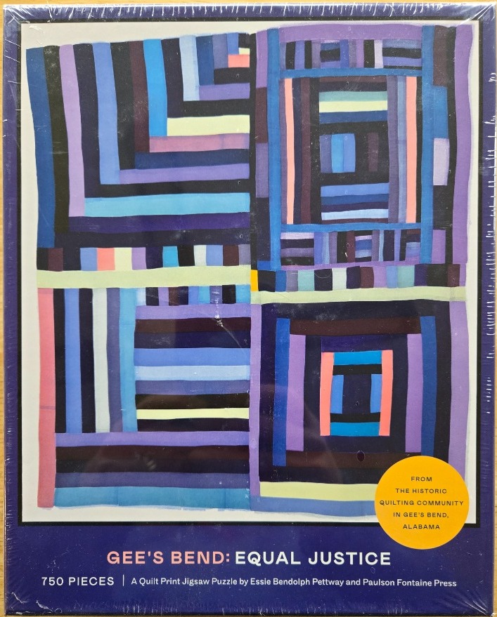 A quilt pattern featuring geometric shapes in shades of blue, purple, and salmon.