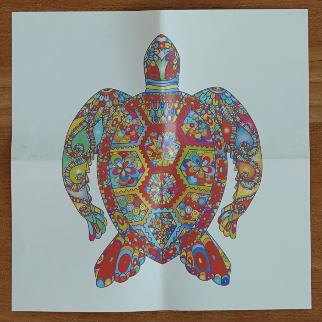 A vibrantly colored sea turtle illustration featuring intricate mandala-style floral and geometric patterns.