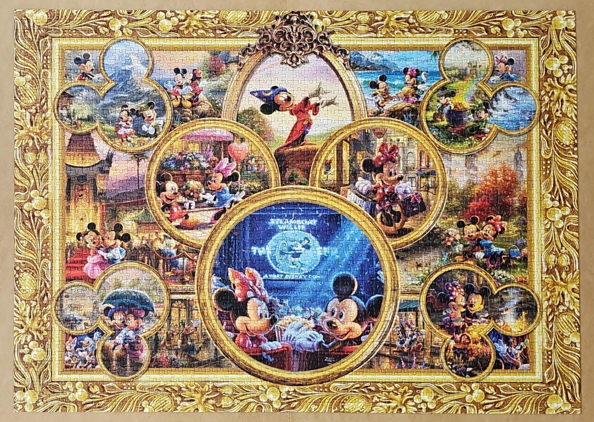 Collage of Mickey and Minnie Mouse scenes inside an ornate gold frame
