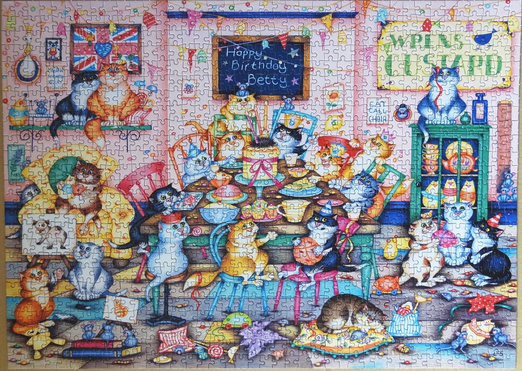 A whimsical illustration of many cats celebrating a birthday party inside a cozy, cluttered room.