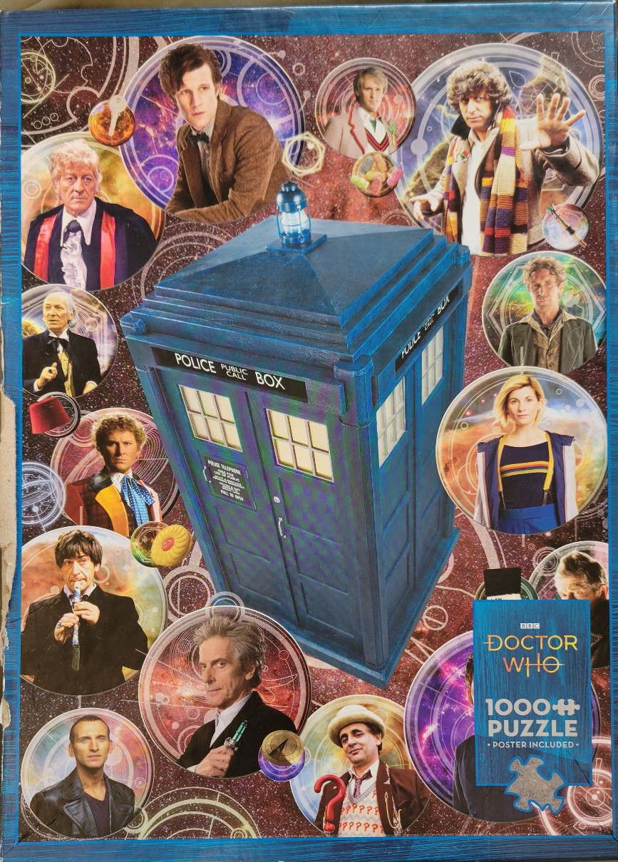 A central blue police box surrounded by various portraits of Doctor Who incarnations against a starry, nebular background.