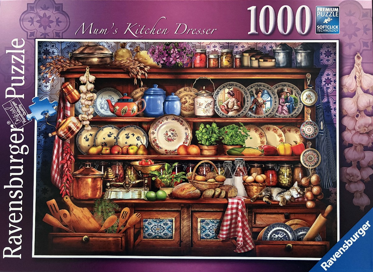 A rustic wooden kitchen dresser overflowing with plates, jars, fresh produce, and a sleeping tabby cat.