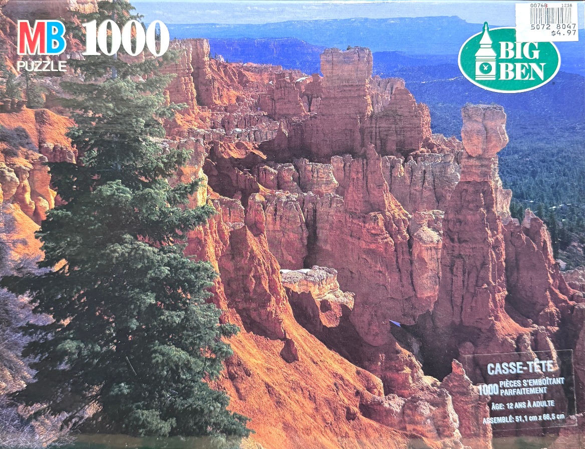 A scenic photograph of Bryce Canyon with prominent orange hoodoos and a large green pine tree in the foreground.