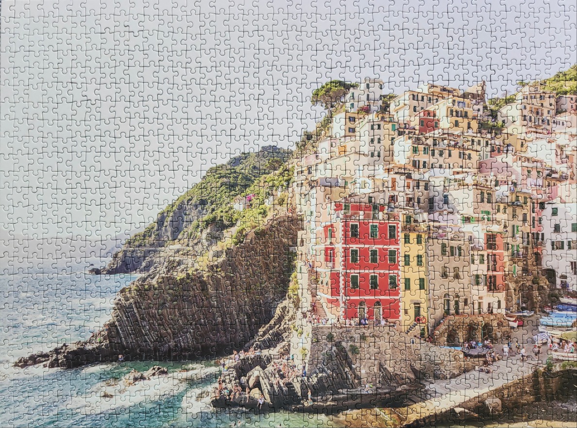 Coastal Italian village of Riomaggiore perched on rocky cliffs above the sea.