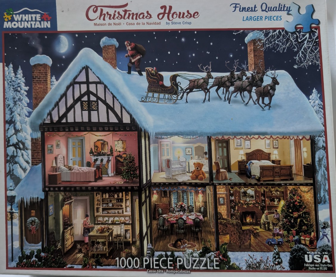 A dollhouse-style cross-section of a two-story home at night with Santa and his sleigh on the snowy roof.