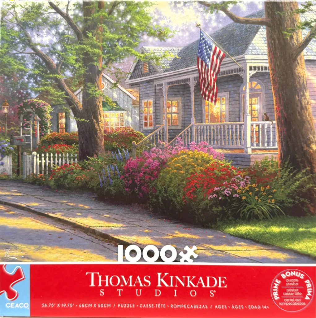 A peaceful suburban home with a white picket fence, a garden, and an American flag on the porch.